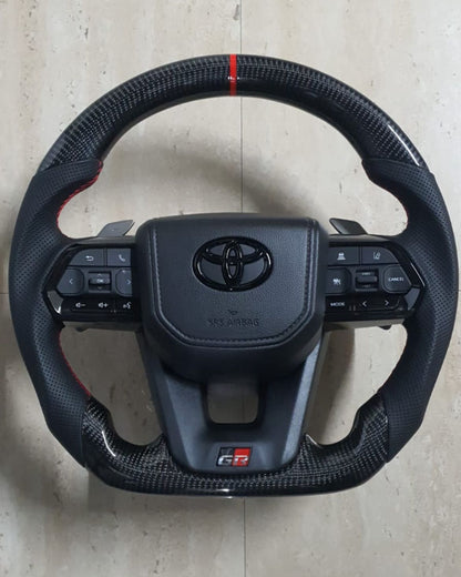 Toyota LC300 Real carbon steering with paddles.